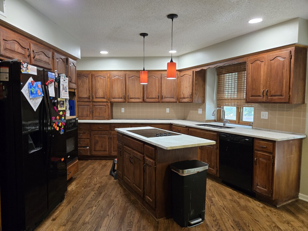 A home kitchen with wrapped white onyx countertops.